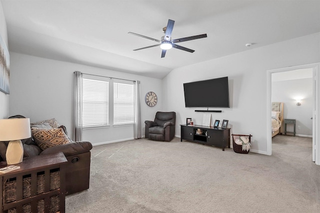 living room with ceiling fan, carpet floors, vaulted ceiling, and baseboards