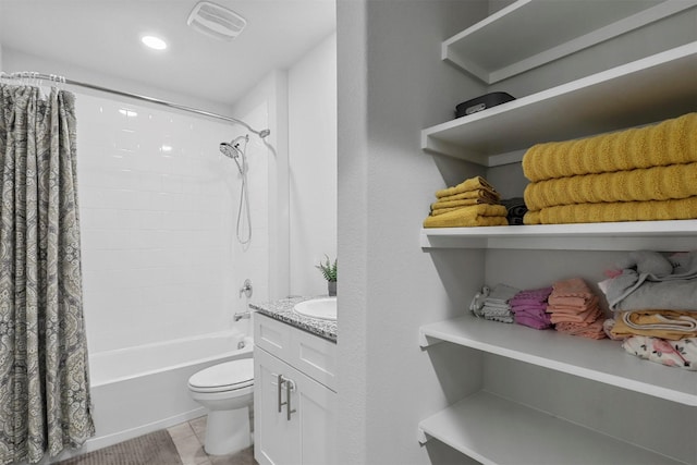 bathroom featuring shower / tub combo with curtain, visible vents, toilet, vanity, and tile patterned flooring