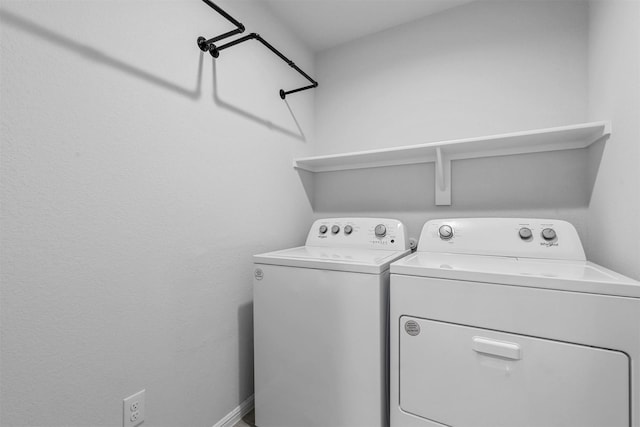 washroom with washing machine and dryer and laundry area