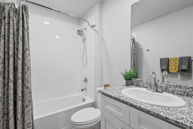 full bathroom featuring shower / tub combo with curtain, vanity, and toilet