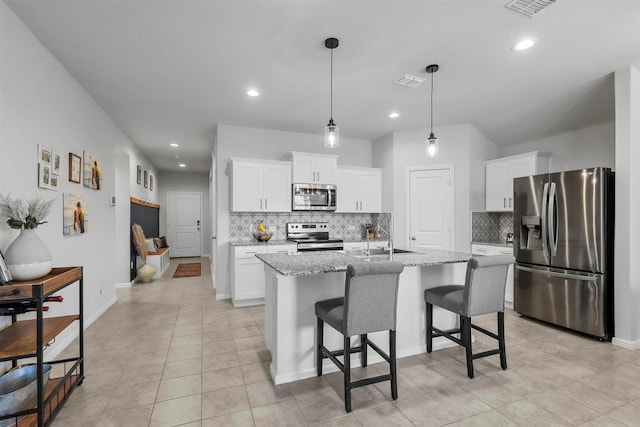 kitchen featuring appliances with stainless steel finishes, visible vents, and white cabinetry