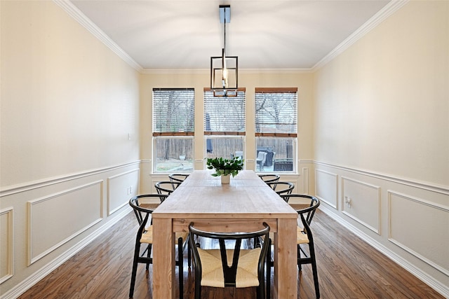 dining room with ornamental molding and dark hardwood / wood-style flooring