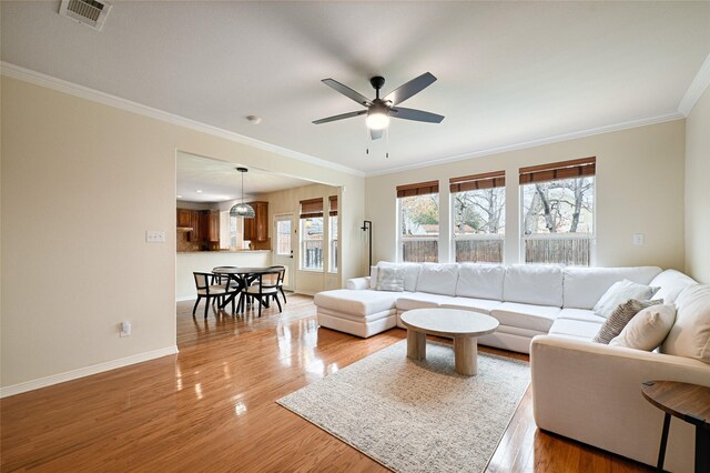 interior details featuring hardwood / wood-style flooring, ornamental molding, and a tile fireplace