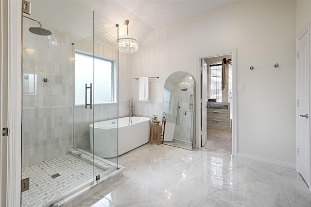 bathroom featuring independent shower and bath and vaulted ceiling