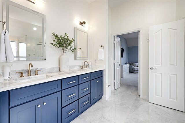 bathroom with a shower with door and vanity