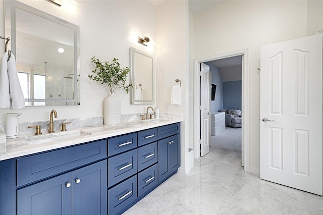 bathroom with vanity and a shower with shower door