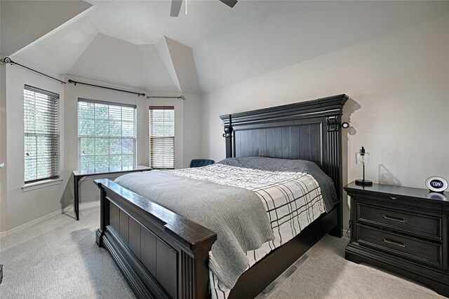 home office with lofted ceiling and light carpet