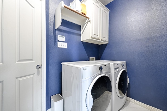 laundry room with cabinets and separate washer and dryer