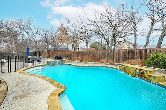 view of swimming pool with pool water feature and an in ground hot tub