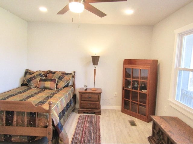 bedroom with ceiling fan and light hardwood / wood-style floors