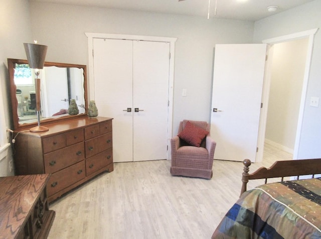 bedroom featuring light hardwood / wood-style floors and a closet