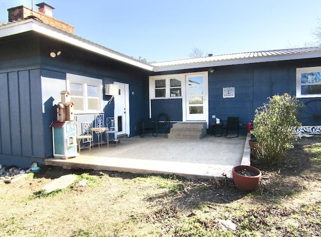 back of house with a patio area and a wall mounted AC