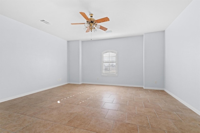 tiled empty room featuring ceiling fan