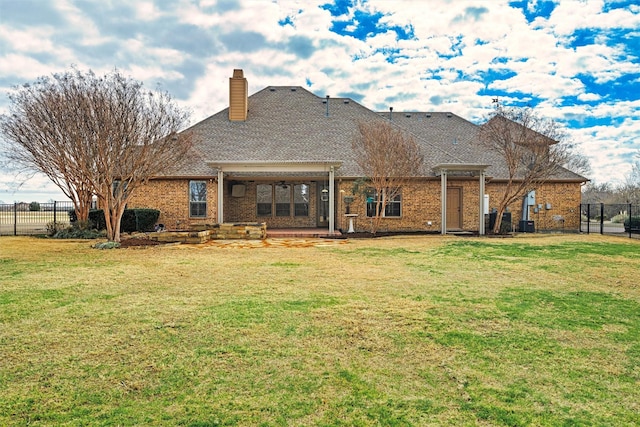 rear view of property with a yard