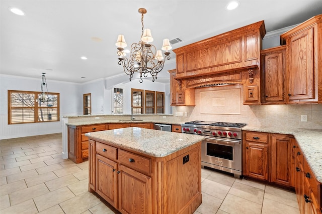 kitchen with decorative light fixtures, sink, ornamental molding, a center island, and stainless steel appliances