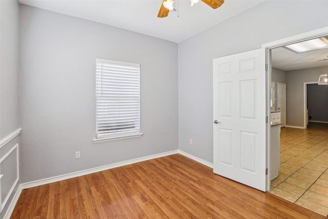 unfurnished bedroom with ceiling fan and light hardwood / wood-style flooring