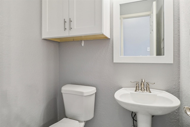 bathroom with sink and toilet