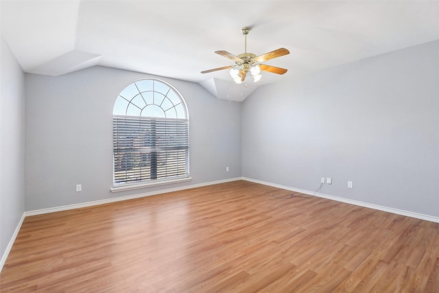 unfurnished room featuring ceiling fan, vaulted ceiling, and light wood-type flooring