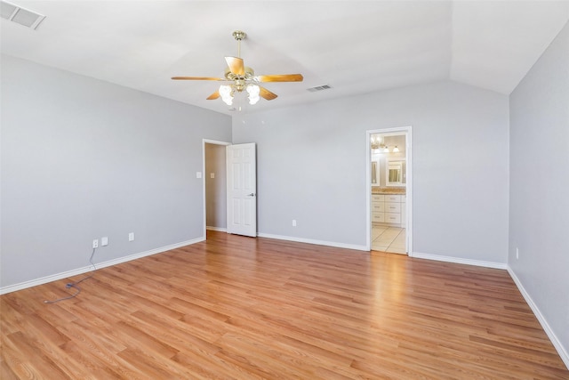 spare room with ceiling fan, lofted ceiling, and light hardwood / wood-style floors