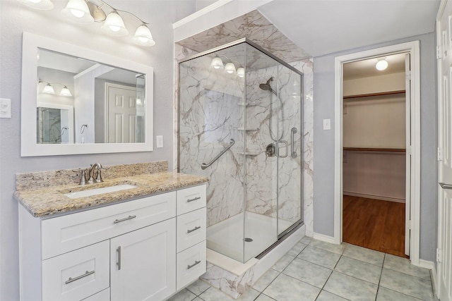 bathroom with vanity, tile patterned flooring, and a shower with door