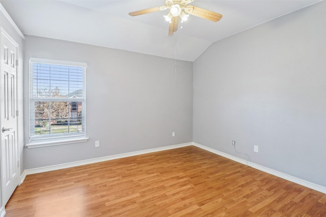 spare room featuring vaulted ceiling, ceiling fan, and light hardwood / wood-style floors