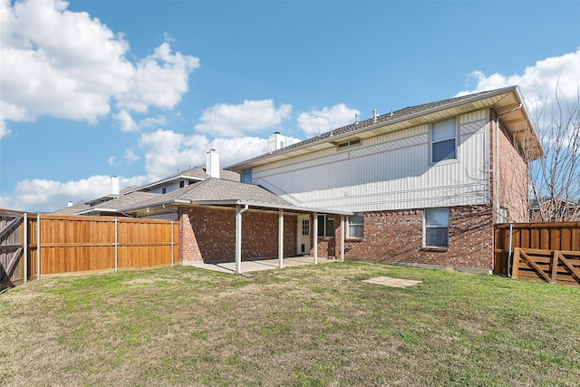 rear view of property featuring a patio area and a lawn