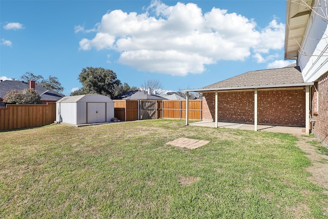 view of yard featuring a shed and a patio area