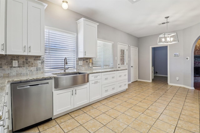 kitchen with white cabinetry, sink, backsplash, stainless steel dishwasher, and light tile patterned floors