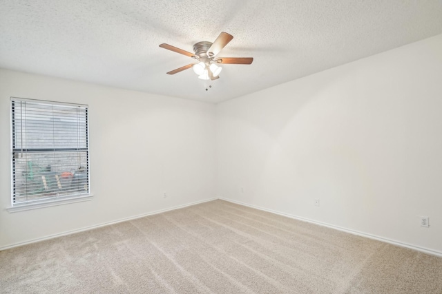 unfurnished room with light carpet, ceiling fan, and a textured ceiling