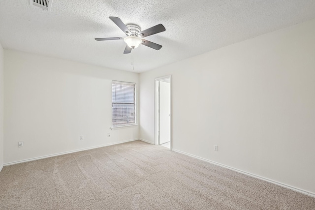 unfurnished room featuring a textured ceiling, light colored carpet, and ceiling fan