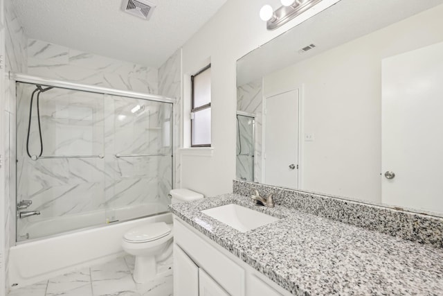 full bathroom with vanity, toilet, shower / bath combination with glass door, and a textured ceiling