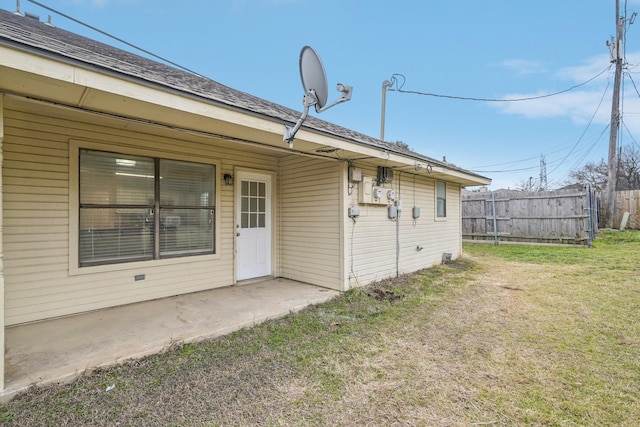 back of property featuring a yard and a patio