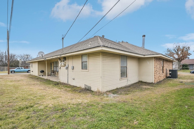 view of home's exterior featuring cooling unit, a patio area, and a lawn