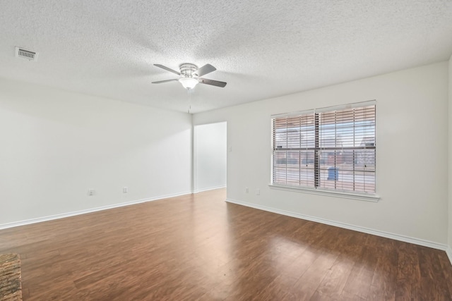 empty room featuring hardwood / wood-style flooring, a textured ceiling, and ceiling fan