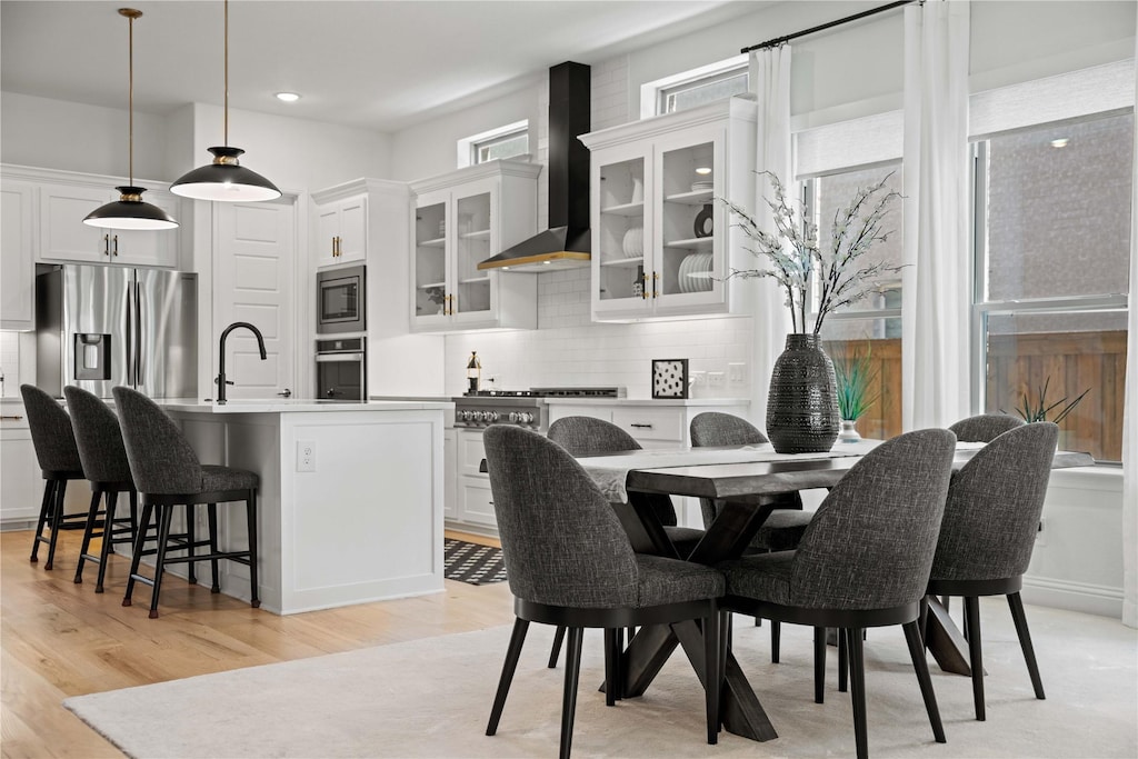 dining area featuring light wood-type flooring