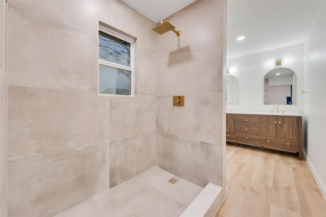 bathroom featuring vanity, hardwood / wood-style floors, and a shower