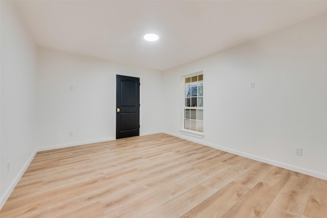 spare room featuring light wood-type flooring