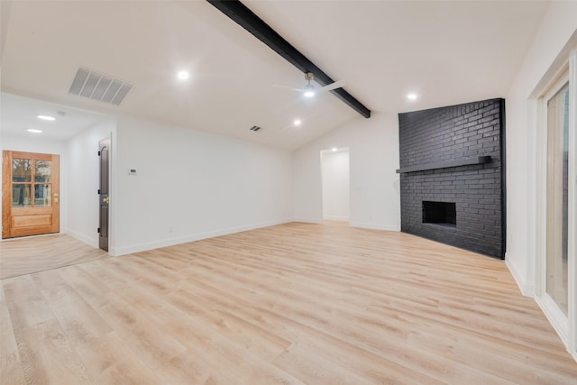 unfurnished living room with a fireplace, lofted ceiling with beams, light hardwood / wood-style floors, and ceiling fan