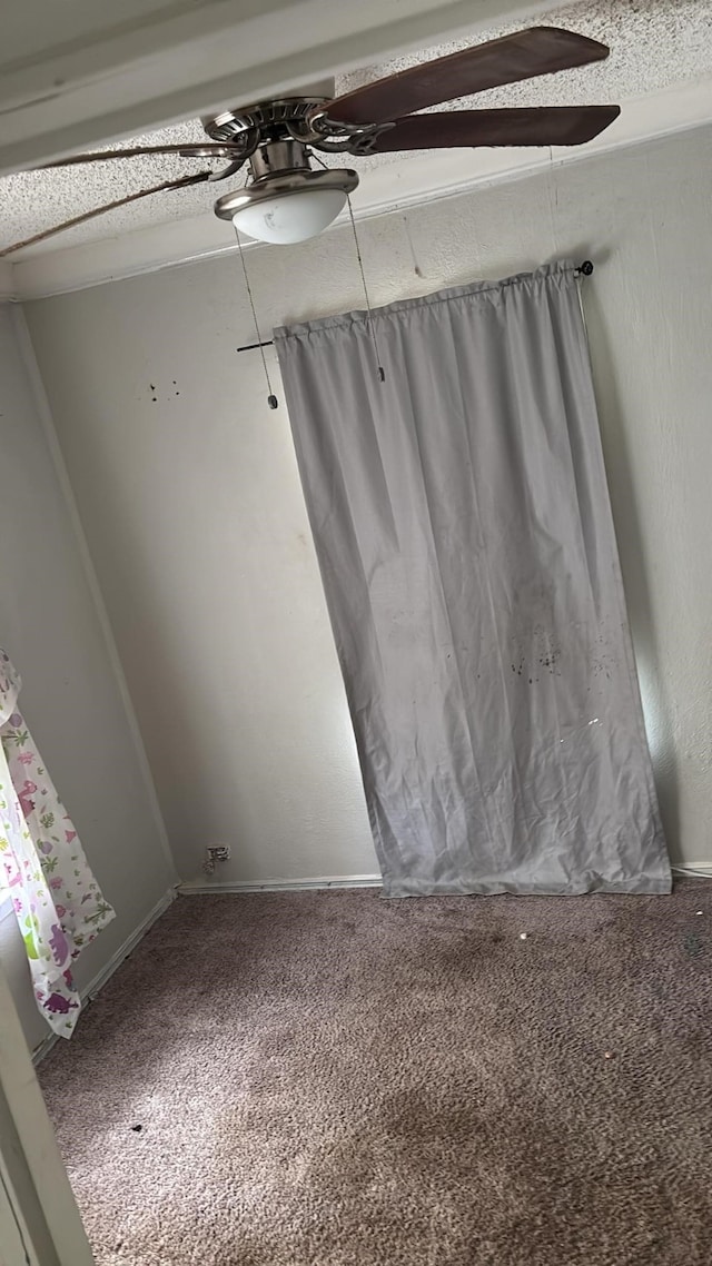 spare room featuring carpet and a ceiling fan