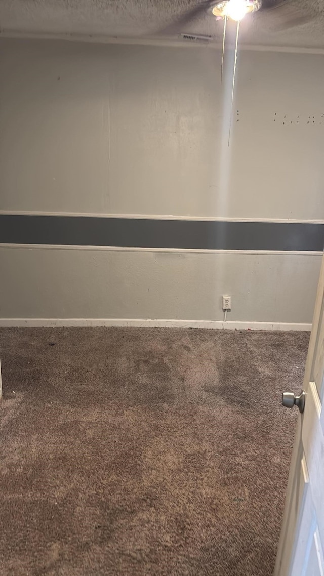 empty room with a textured ceiling and carpet