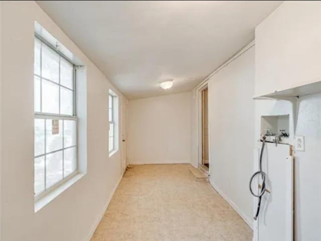 unfurnished room featuring baseboards