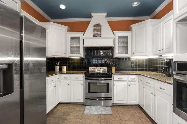 kitchen with light tile patterned floors, stainless steel appliances, custom range hood, and white cabinets