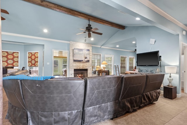 tiled living room with vaulted ceiling with beams, a fireplace, ornamental molding, and ceiling fan