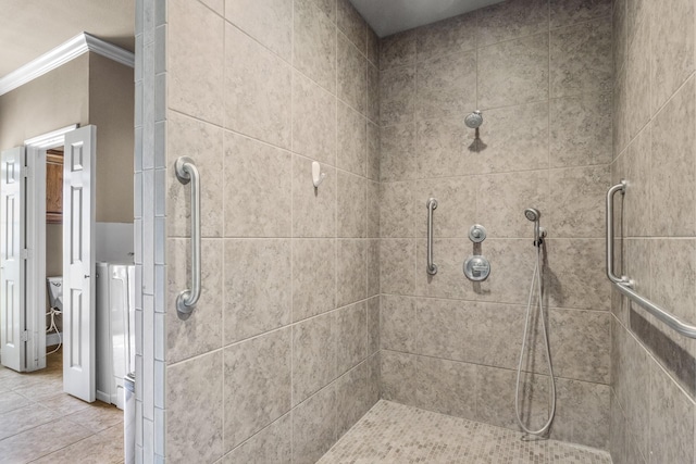 bathroom with tiled shower and ornamental molding