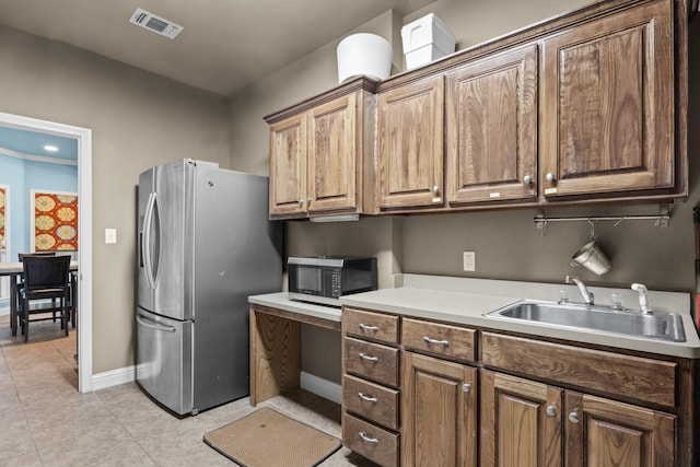 kitchen featuring sink and stainless steel fridge with ice dispenser