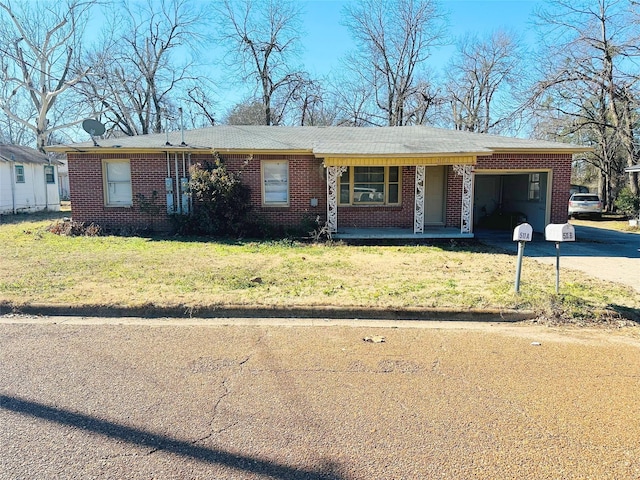 ranch-style home with a carport and a front yard