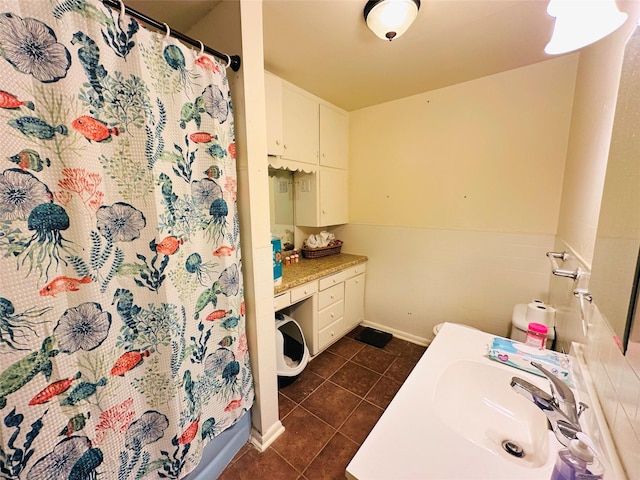 bathroom with tile patterned flooring, vanity, and tile walls