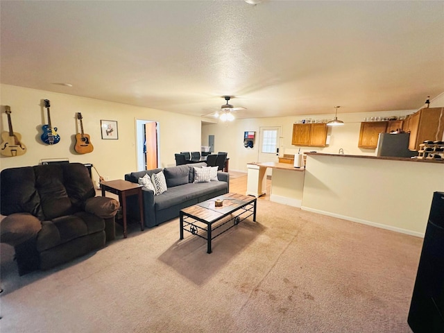 carpeted living room featuring ceiling fan