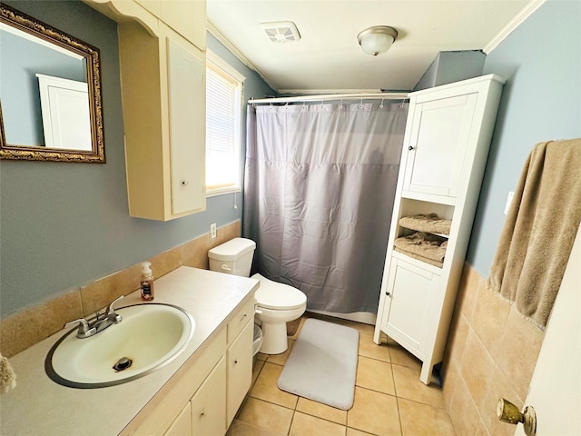 bathroom with crown molding, vanity, tile patterned floors, toilet, and walk in shower