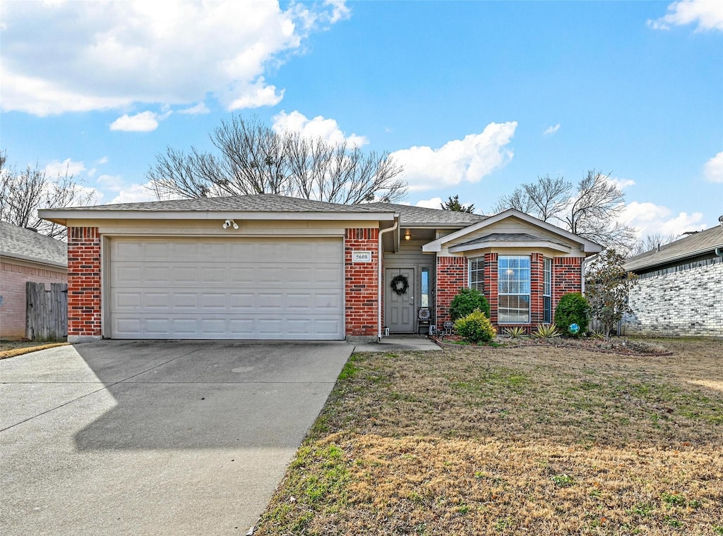 ranch-style home with a garage and a front lawn